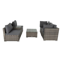 Outdoor modular grey lounge sofa set with wicker end table and pillows - a good choice for relaxing outside