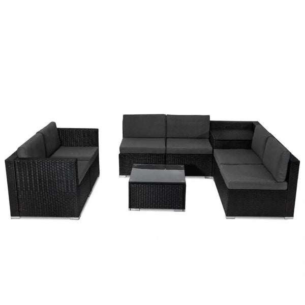 Black rattan patio furniture set with modular lounge sofa, coffee table, and chairs