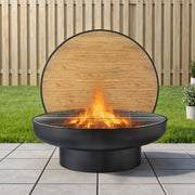 Black fire pit with wooden cover on a patio
