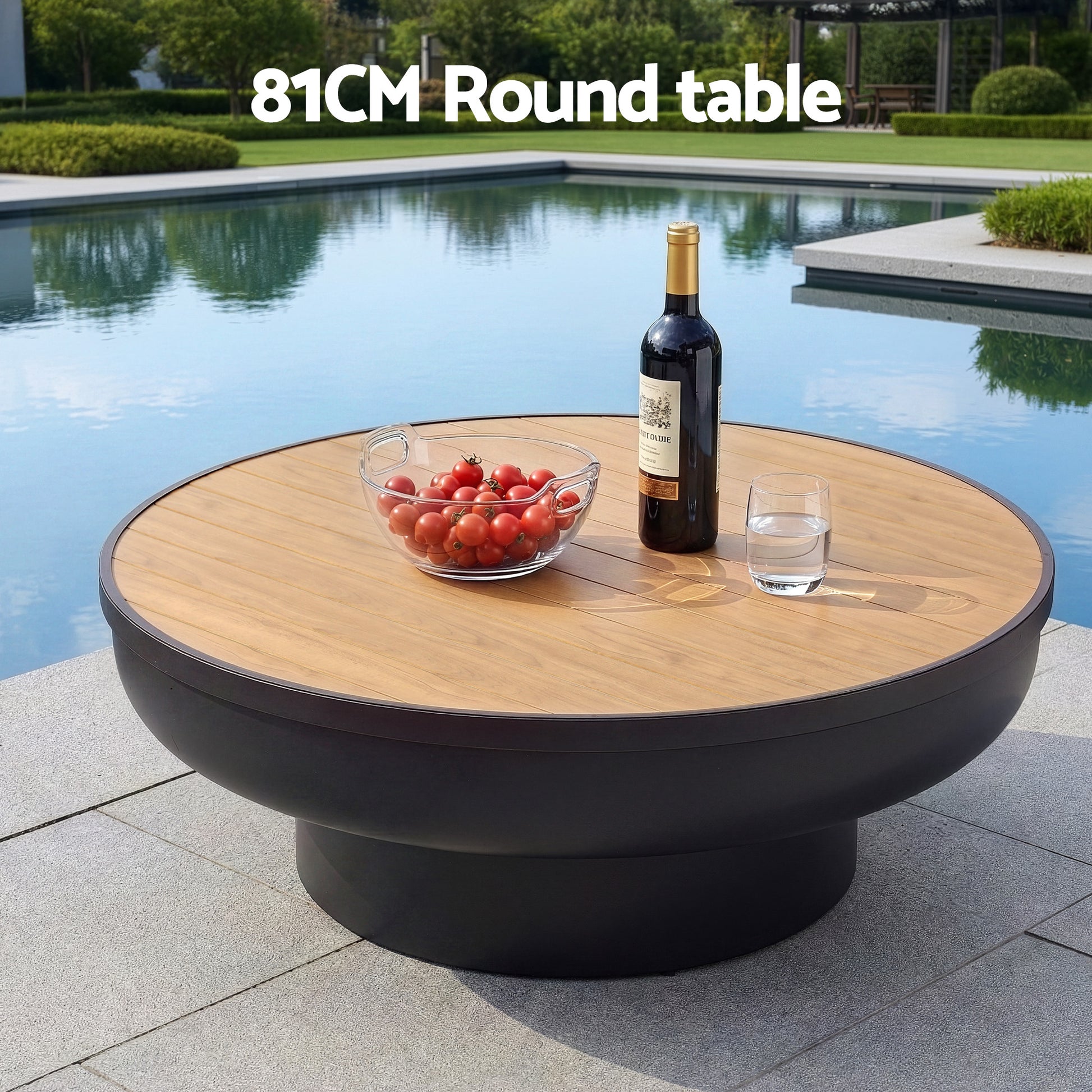 Round table with a bottle, glass, and bowl by a pool