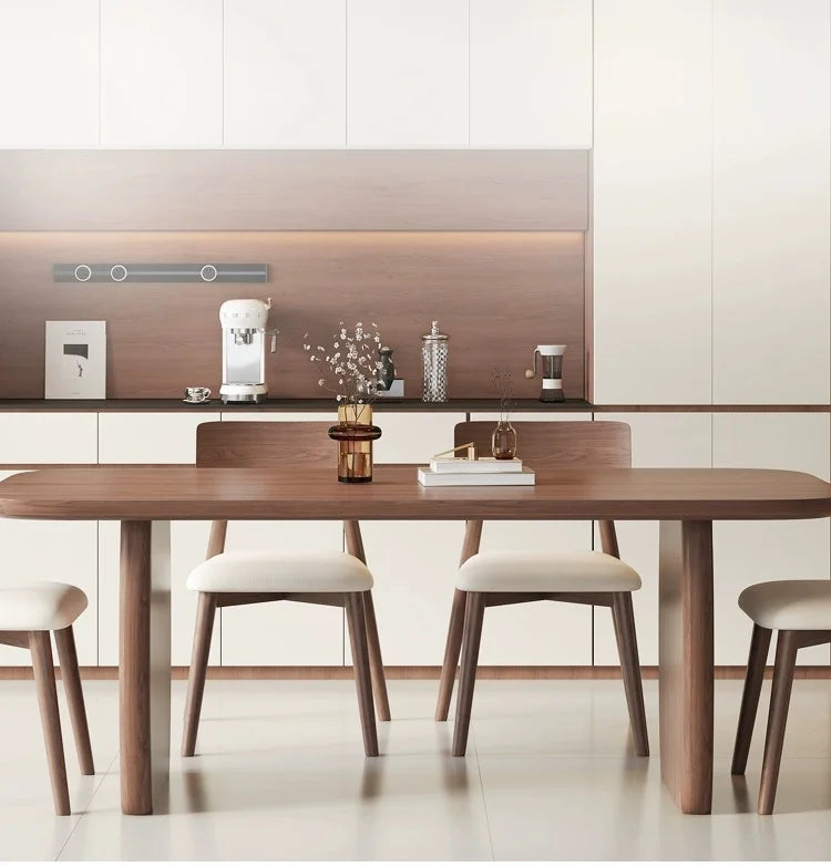 Dining area with wooden table and chairs in a modern kitchen setting.
