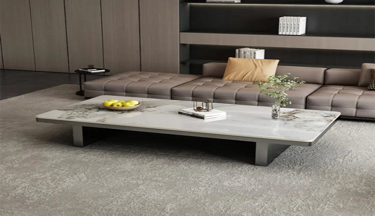 Modern living room with a gray sectional sofa and marble coffee table.