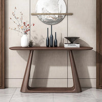 Wooden console table with decorative items against a neutral wall