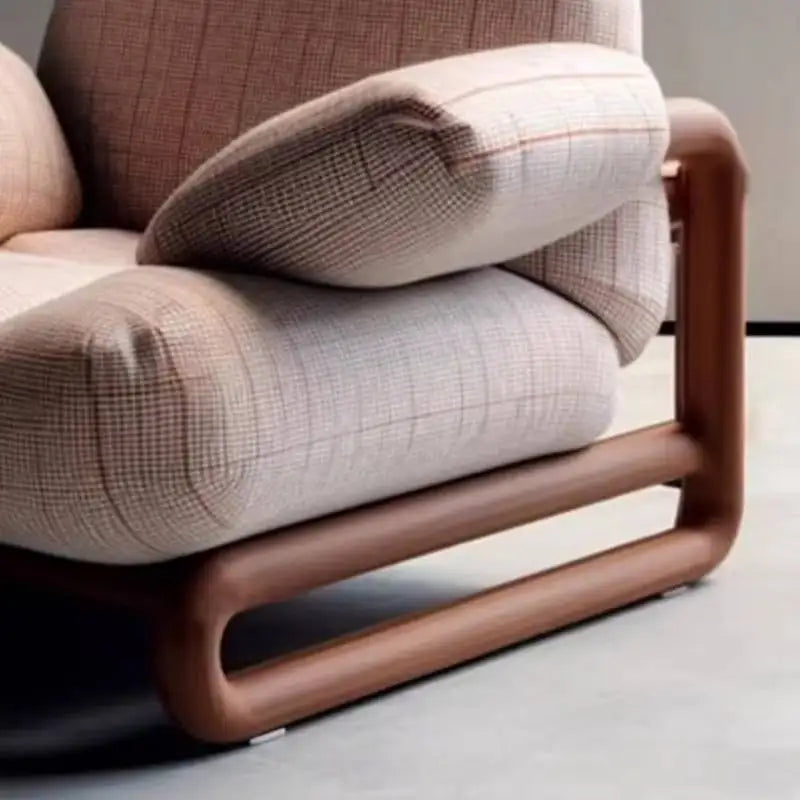 Modern chair with plaid fabric and wooden frame on a neutral background