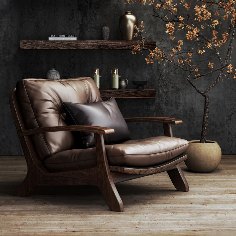 Brown leather armchair in a room with a dark wall, shelf, and decorative plant.