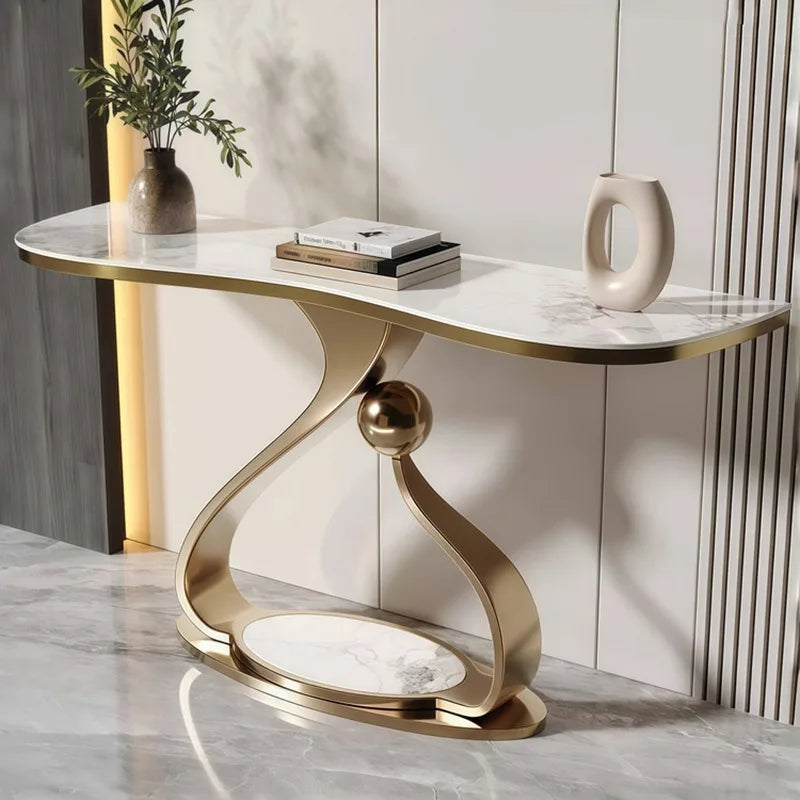Modern console table with marble top and gold base against a neutral wall.