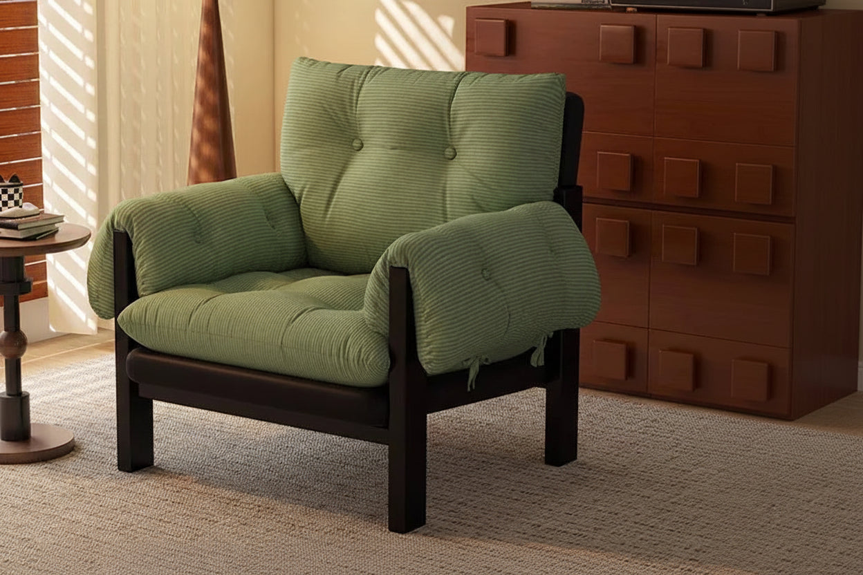 Green cushioned chair with ottoman in a room setting