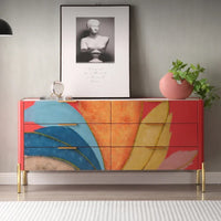 Colorful dresser with abstract design in a room with a framed picture and plant.
