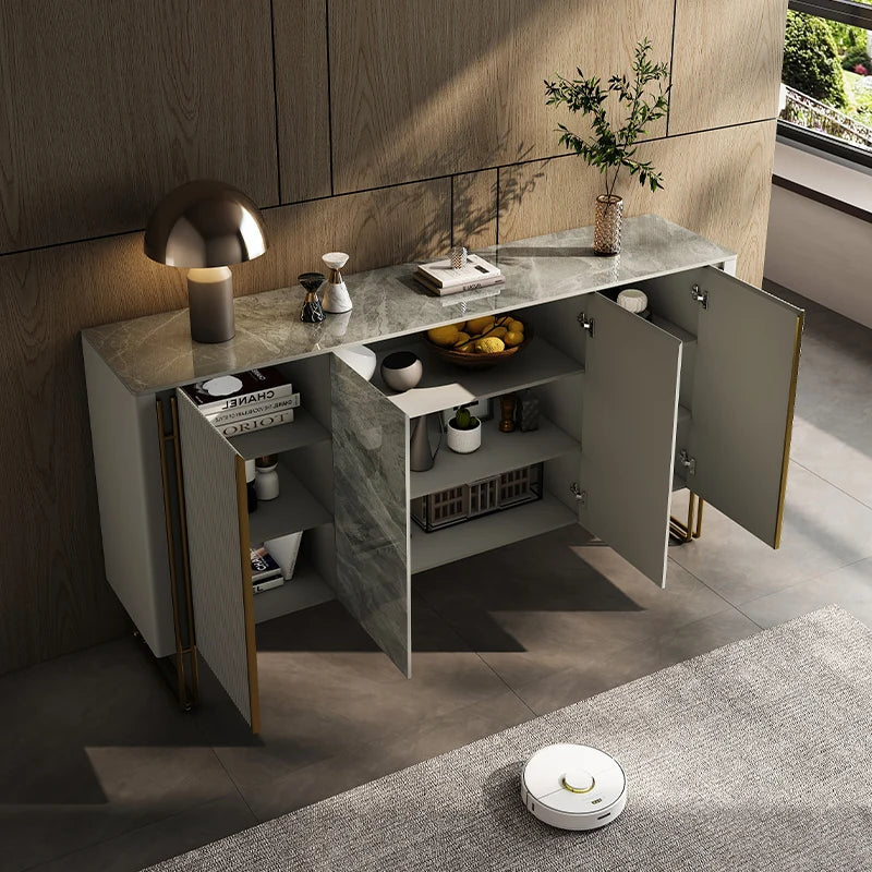 Modern kitchen with open cabinets, decorative items, and a robot vacuum cleaner on the floor.