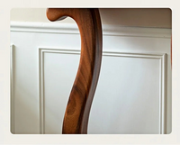 Close-up of a wooden leg on a white cabinet with text describing the robustness of the wood.