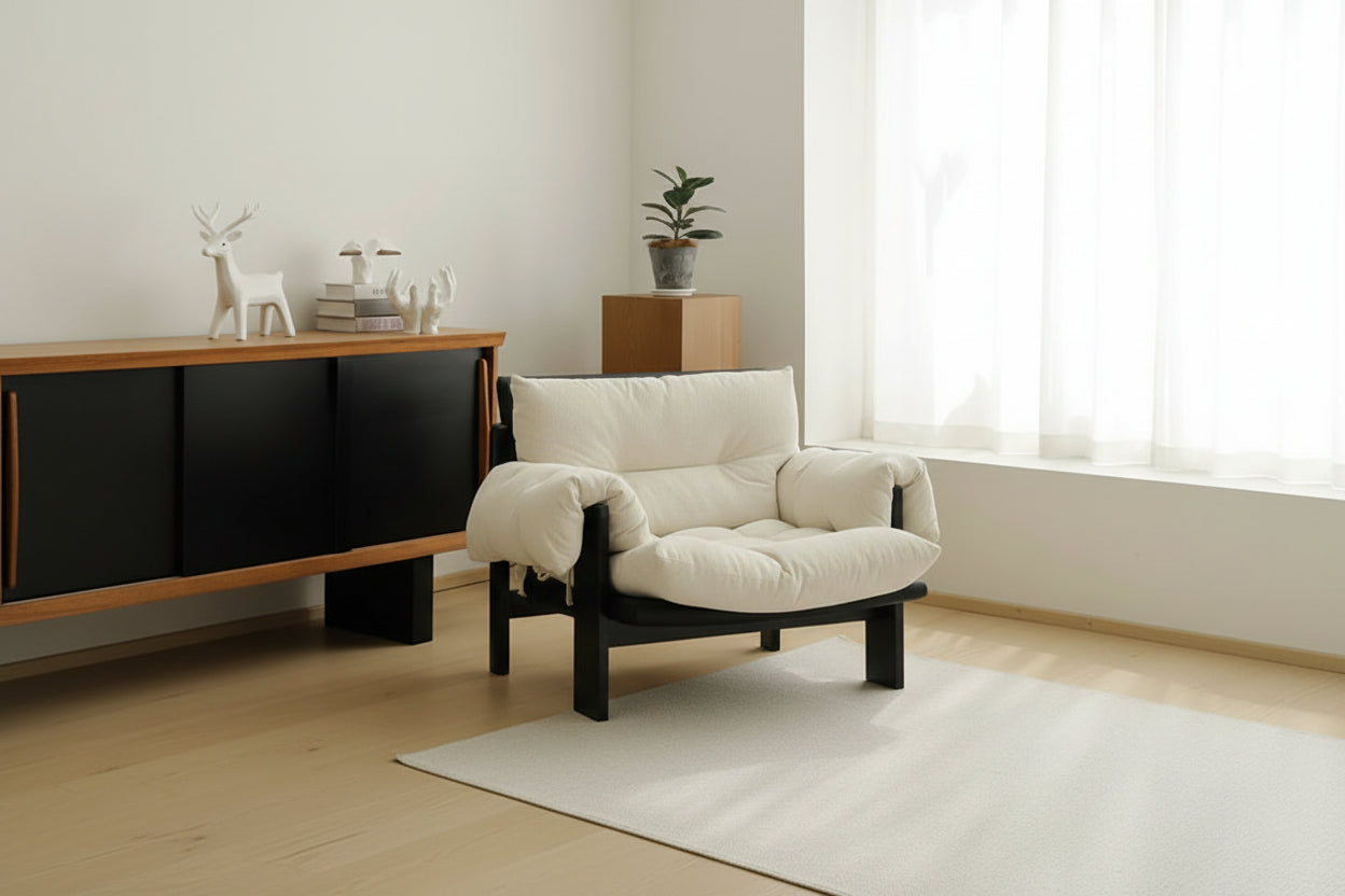 Person sitting on a modern chair reading a book in a cozy room.