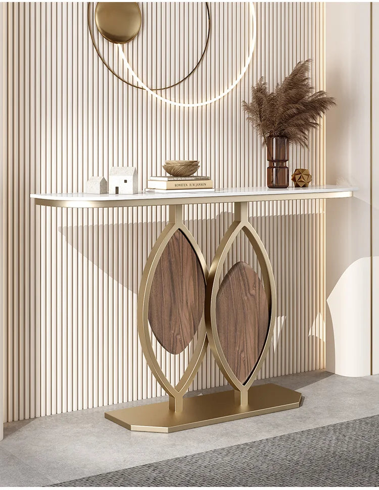 Decorative console table with leaf design legs against a neutral wall.