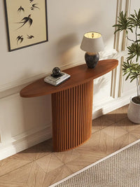 Wooden console table with decorative items in a room setting