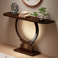 Wooden console table with decorative items against a beige wall