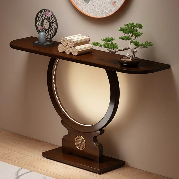 Wooden console table with decorative items against a beige wall