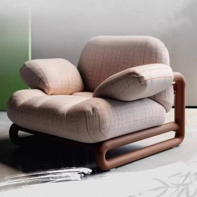 Modern beige armchair with wooden frame on a light gray floor.
