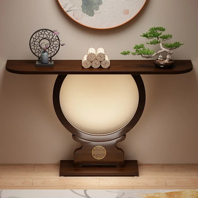 Decorative console table with a spherical lamp and small plants in a room setting.
