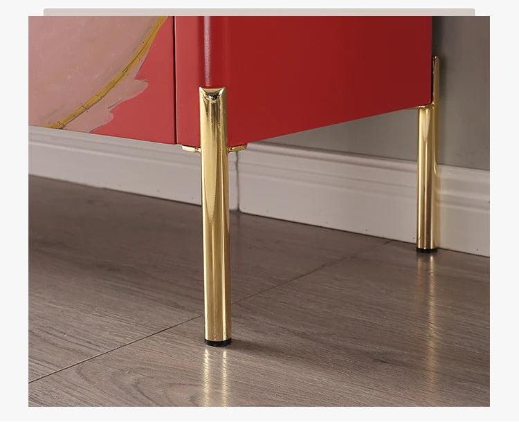 Red cabinet with gold stainless steel feet on a wooden floor