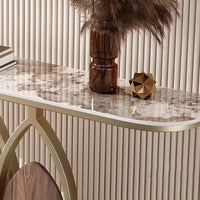 Marble console table with decorative items against a neutral wall