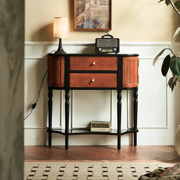 Wooden console table with black legs in a room setting