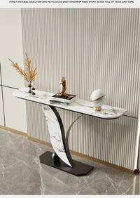Modern console table with decorative items against a striped wall.