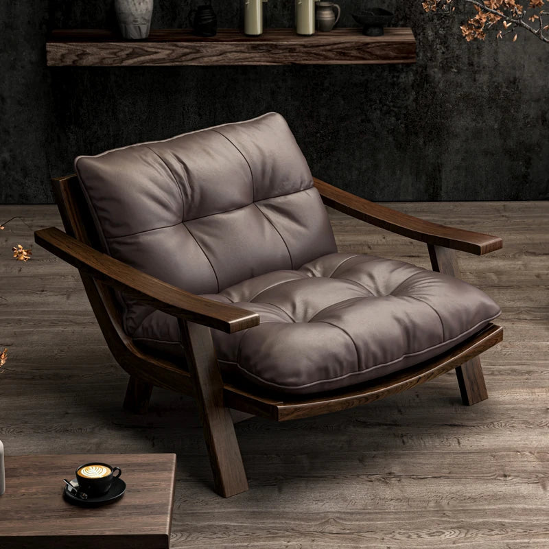 Brown leather armchair on a wooden floor with a dark wall background