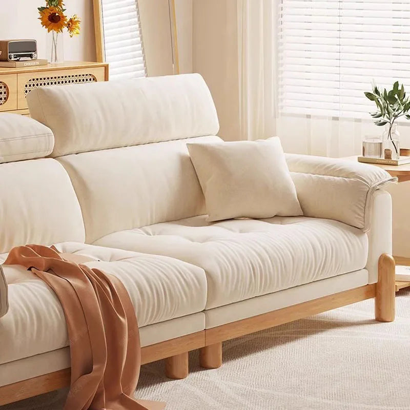 Beige sofa with wooden legs in a living room setting