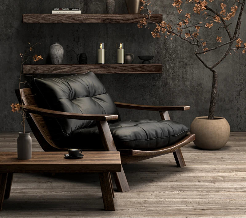 Modern black leather armchair in a stylish room with wooden shelves and decor.