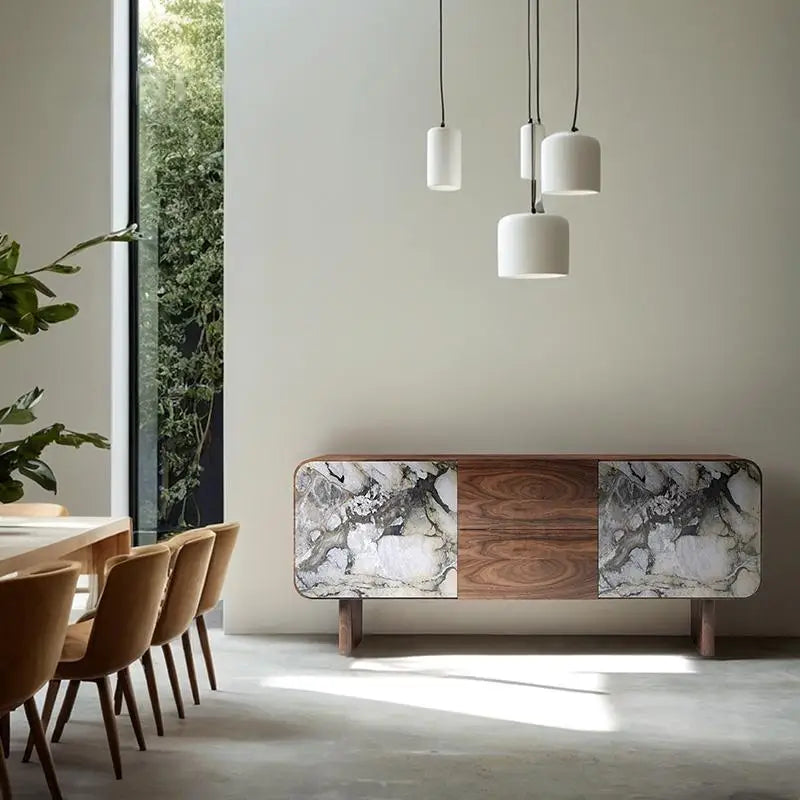 Modern interior with a console table featuring marble and wood design, pendant lights, and a dining area.