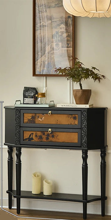 Small black side table with decorative elements in a room setting, showing dimensions.
