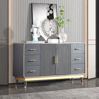Gray dresser with gold handles in a room setting