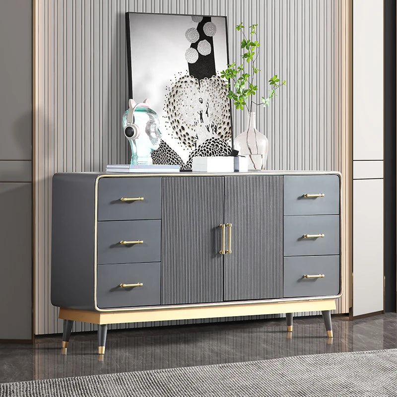 Gray dresser with gold handles in a room setting