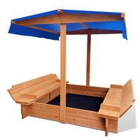 Wooden sandbox with blue canopy on a white background