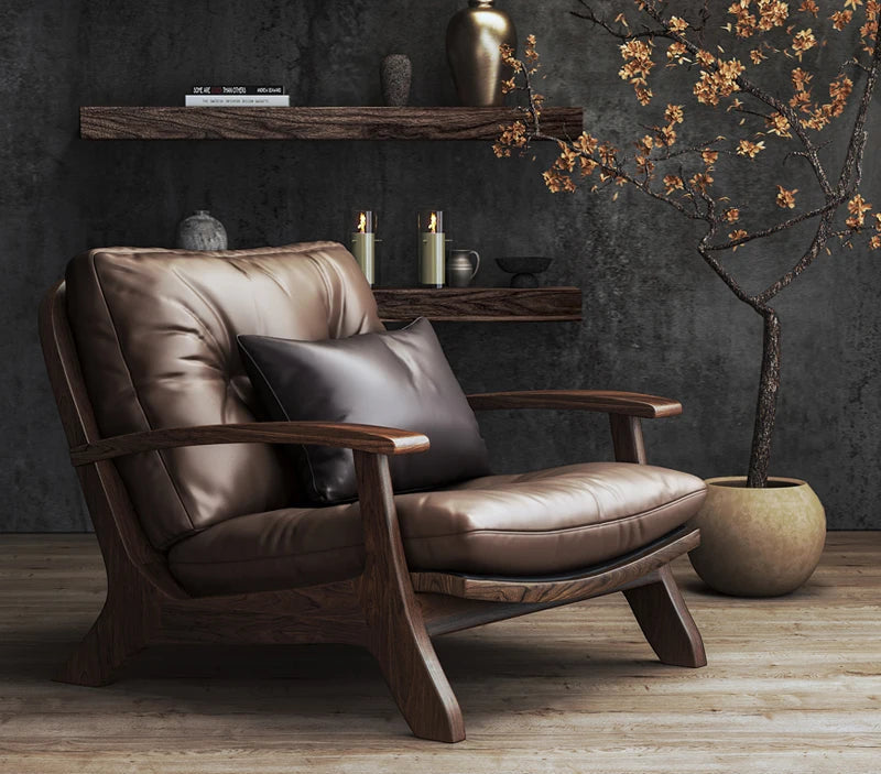 Brown leather armchair in a room with dark walls and decorative elements.