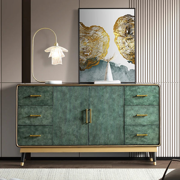 Modern green dresser with gold accents in a stylish room.