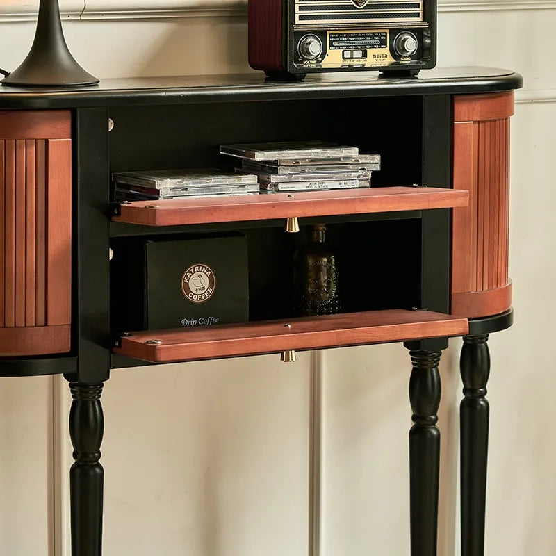 Wooden side table with a vintage radio and books on a neutral background
