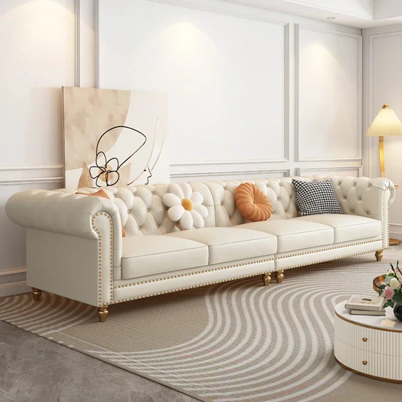 White tufted sofa with decorative pillows in a stylish living room setting.