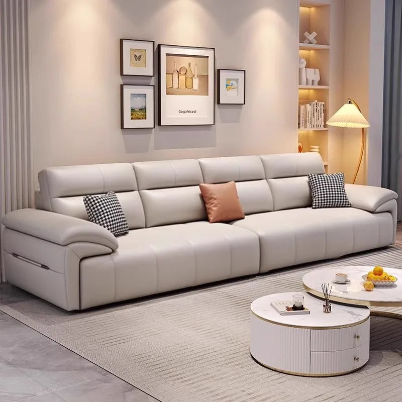 Modern living room with a beige sectional sofa, round coffee table, and decorative pillows.