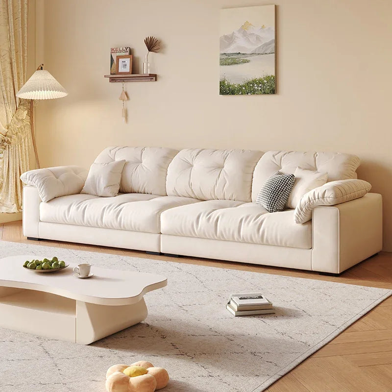Modern living room with a white sofa, coffee table, and decorative items.