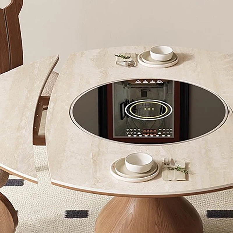 Round dining table with built-in electric stove and ceramic bowls on a light-colored floor.