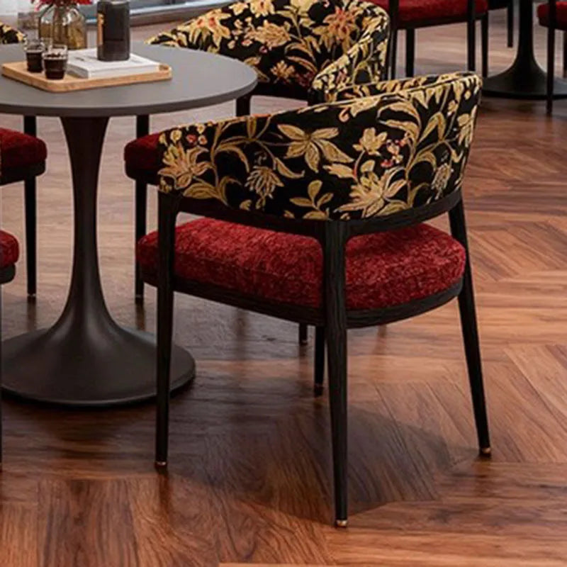 Chair with floral patterned backrest and red seat in a restaurant setting