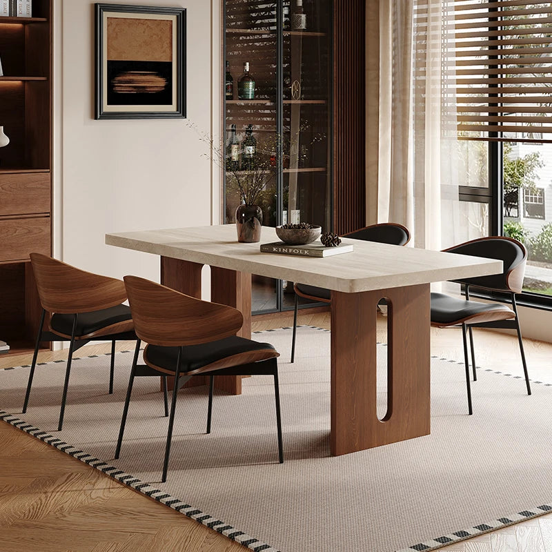 Modern dining room with a wooden table and chairs in a well-lit room.