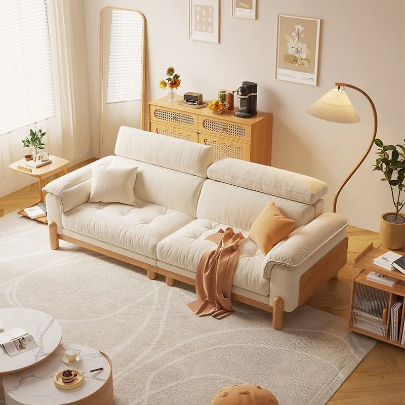 Cozy living room with a beige sofa, coffee table, and decorative items.