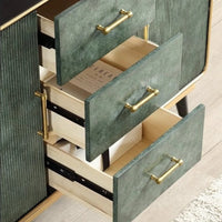 Green textured drawer set with gold handles on a light wooden floor.
