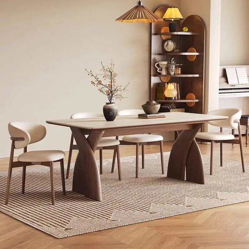 Dining room with a modern wooden table and chairs on a patterned rug.