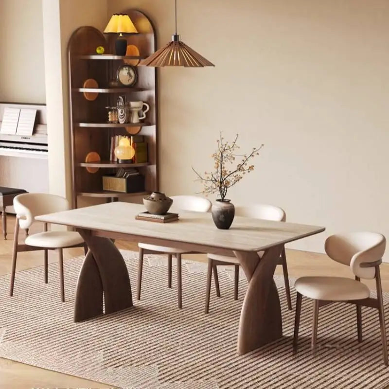 Dining room with a modern table and chairs, bookshelf, and decorative elements.