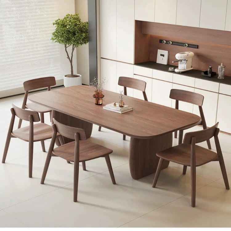 Dining area with wooden table and chairs in a modern kitchen.