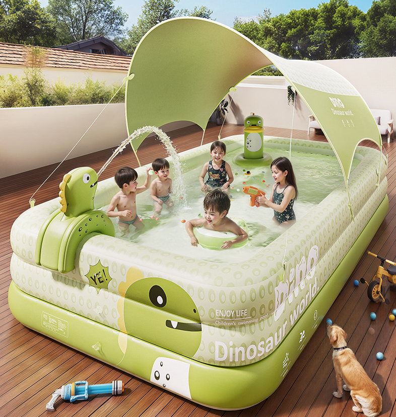 Children playing in a dinosaur-themed inflatable pool on a wooden deck with a dog nearby.
