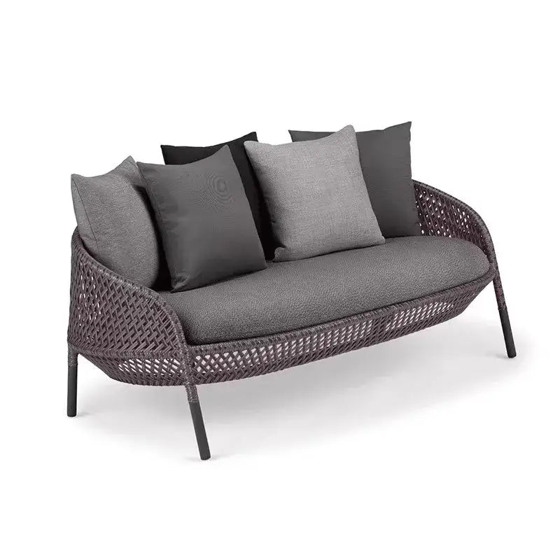 Wicker outdoor sofa with gray cushions on a white background