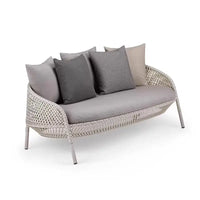 Wicker outdoor sofa with gray cushions on a white background
